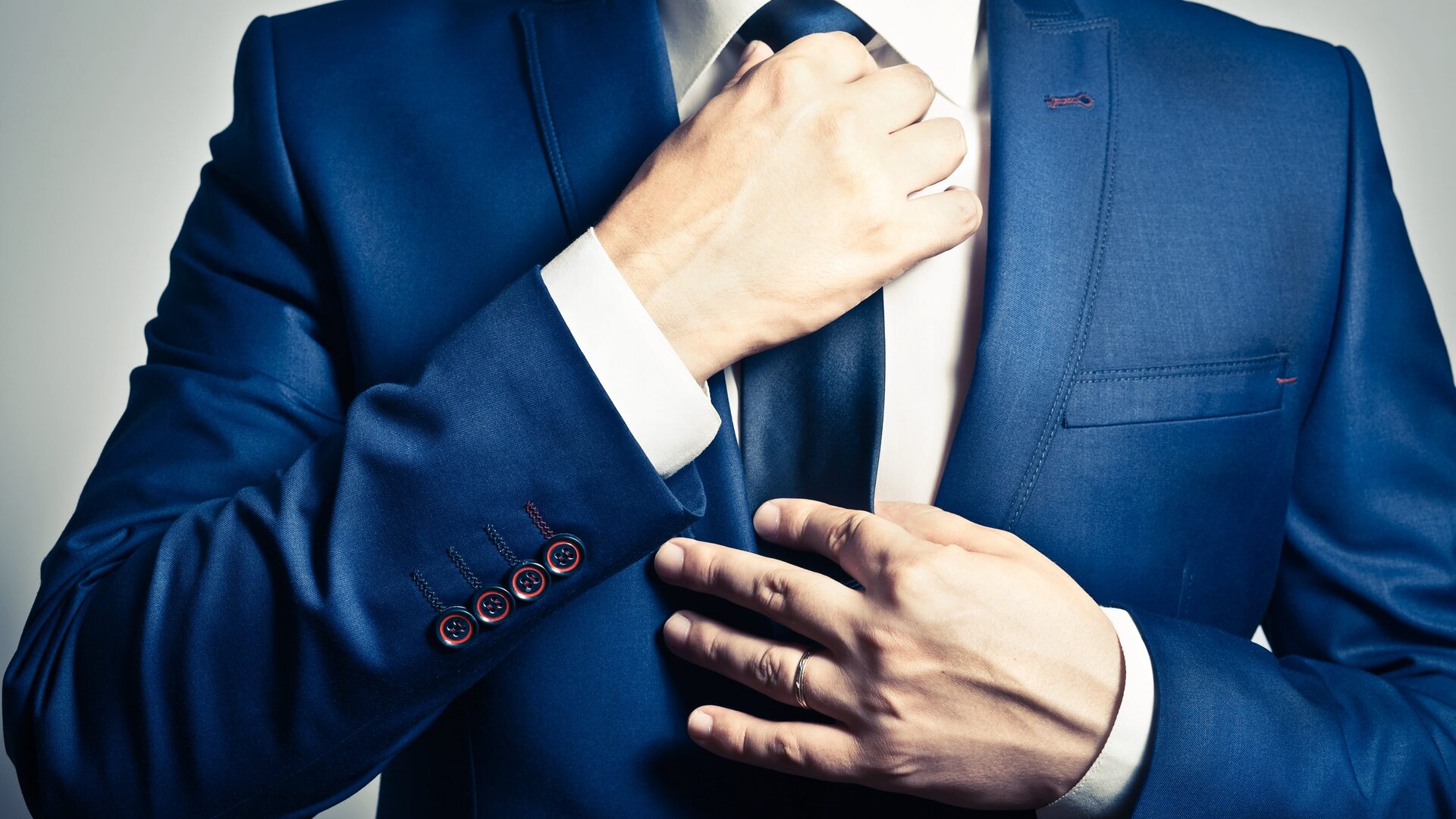 Stylish man adjusting attire in editorial style
