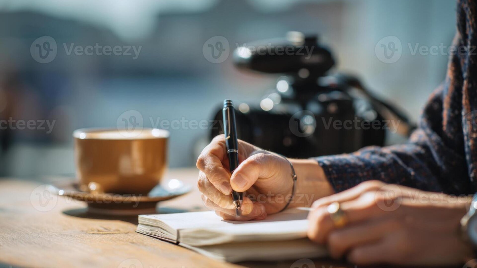Gentleman writing in a leather journal at a cafe